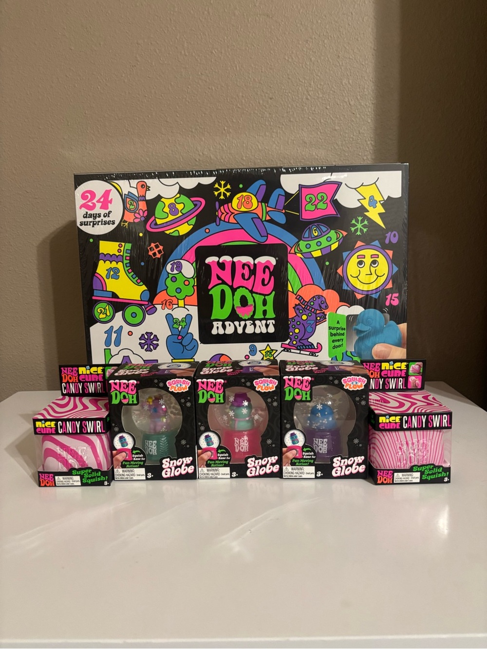 NeeDoh Advent Calendar with Candy Swirl Cubes and Snow Globes - Squishmas Bundle